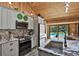 Modern kitchen with an island, stainless steel appliances, and a view of the backyard pool at 2515 Pemberton Creek Dr, Seffner, FL 33584
