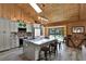 Modern kitchen featuring a large island with granite countertops, stainless steel appliances, and wood paneling at 2515 Pemberton Creek Dr, Seffner, FL 33584