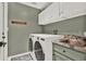 Well-equipped laundry room with modern appliances and ample storage at 2515 Pemberton Creek Dr, Seffner, FL 33584