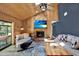 Inviting living room with stone fireplace, wood-paneled ceiling, comfortable seating, and access to outdoor spaces at 2515 Pemberton Creek Dr, Seffner, FL 33584