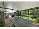 Spacious screened-in patio with ping pong table, grill, and seating, perfect for outdoor entertaining at 2515 Pemberton Creek Dr, Seffner, FL 33584