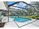 Beautiful screened-in pool with integrated spa and attractive backyard, perfect for outdoor entertaining at 2515 Pemberton Creek Dr, Seffner, FL 33584