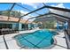 Beautiful screened-in pool with integrated spa, view of the home, and attractive backyard at 2515 Pemberton Creek Dr, Seffner, FL 33584