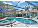 Beautiful screened-in pool with integrated spa, view of the home, and attractive backyard at 2515 Pemberton Creek Dr, Seffner, FL 33584