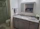 Bathroom featuring granite countertops, modern vanity, framed mirror, and glass shower at 2588 Laurelwood Dr # 16A, Clearwater, FL 33763