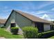 Exterior shot of the home showcasing the roofline and lush landscaping at 2588 Laurelwood Dr # 16A, Clearwater, FL 33763