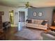 Cozy living room featuring a comfortable sofa, ceiling fan, and hardwood floors at 2588 Laurelwood Dr # 16A, Clearwater, FL 33763