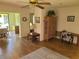 Hardwood floors throughout the living room with open access to dining area and outside at 2588 Laurelwood Dr # 16A, Clearwater, FL 33763