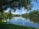 Picturesque view of the serene pond and reflected clouds at 2588 Laurelwood Dr # 16A, Clearwater, FL 33763