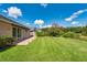 Spacious backyard with patio, lush green grass, and well-maintained landscaping at 27652 Sky Lake Cir, Wesley Chapel, FL 33544