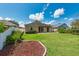 Backyard featuring a well-maintained lawn, perimeter garden beds, and privacy fencing at 27652 Sky Lake Cir, Wesley Chapel, FL 33544
