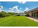 Expansive backyard featuring lush lawn and perimeter landscaping for privacy and outdoor enjoyment at 27652 Sky Lake Cir, Wesley Chapel, FL 33544