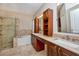 Bathroom with double sinks, vanity, walk-in shower and soaking tub at 27652 Sky Lake Cir, Wesley Chapel, FL 33544
