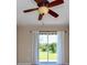 Bedroom with neutral carpet, ceiling fan, and sliding glass doors to the backyard at 27652 Sky Lake Cir, Wesley Chapel, FL 33544