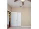 A bedroom featuring neutral walls, carpet, ceiling fan and standard closet at 27652 Sky Lake Cir, Wesley Chapel, FL 33544