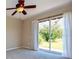 Bedroom with neutral carpet, ceiling fan, and sliding glass doors to the backyard at 27652 Sky Lake Cir, Wesley Chapel, FL 33544