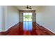 Bright living room featuring hardwood floors, a ceiling fan, and sliding glass doors to the outside at 27652 Sky Lake Cir, Wesley Chapel, FL 33544