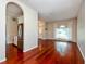 Bright living room featuring gleaming hardwood floors and seamless access to kitchen at 27652 Sky Lake Cir, Wesley Chapel, FL 33544