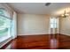 Bright living room with hardwood floors, large windows, and flowing white curtains at 27652 Sky Lake Cir, Wesley Chapel, FL 33544