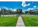 Tennis courts offering recreational opportunities, enclosed by fencing with landscaping, under a bright sky at 27652 Sky Lake Cir, Wesley Chapel, FL 33544