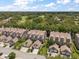 This aerial view showcases townhomes with lush landscaping and a nearby golf course in a desirable neighborhood at 2804 Countryside Blvd # 4, Clearwater, FL 33761
