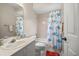 Bright bathroom features a shower-tub combo with a delightful mermaid shower curtain and white fixtures at 2804 Countryside Blvd # 4, Clearwater, FL 33761