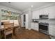 Bright kitchen with modern appliances, white cabinets, and a breakfast nook with backyard views at 2804 Countryside Blvd # 4, Clearwater, FL 33761