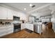 Well-lit kitchen boasts stainless steel appliances, white cabinetry, and granite countertops at 2804 Countryside Blvd # 4, Clearwater, FL 33761