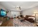 Spacious living room with hardwood floors, a large window with shutters, and comfortable leather furniture at 2804 Countryside Blvd # 4, Clearwater, FL 33761