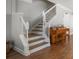 Elegant staircase with wood treads and white risers, accented by classic wood trim at 2804 Countryside Blvd # 4, Clearwater, FL 33761