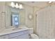 This bathroom has a toilet, a shower with curtain, and a modern vanity at 2866 Quail Crest Ct, Valrico, FL 33594