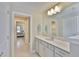 Bright bathroom featuring a white vanity with a quartz countertop and a large mirror at 2866 Quail Crest Ct, Valrico, FL 33594