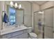 Modern bathroom with glass shower, vanity, mirror and views into the primary bedroom at 2866 Quail Crest Ct, Valrico, FL 33594