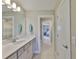 Bright bathroom featuring a long sink counter and a view to a bedroom through the doorway at 2866 Quail Crest Ct, Valrico, FL 33594