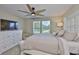 Cozy bedroom features a large bed, soft carpet, a ceiling fan and sun filled windows at 2866 Quail Crest Ct, Valrico, FL 33594