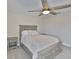 This bedroom boasts a ceiling fan and neutral gray tones in the furnishings and walls at 2866 Quail Crest Ct, Valrico, FL 33594