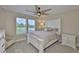 Bedroom features a large bed, soft carpet, a ceiling fan and sun filled windows at 2866 Quail Crest Ct, Valrico, FL 33594