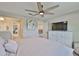 Bedroom features a large bed, soft carpet, a ceiling fan and a storage cabinet with a television at 2866 Quail Crest Ct, Valrico, FL 33594