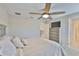 Bright bedroom with a ceiling fan, dresser with television, and access to an upstairs hallway at 2866 Quail Crest Ct, Valrico, FL 33594