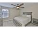 Cozy bedroom featuring a ceiling fan and a large window providing natural light at 2866 Quail Crest Ct, Valrico, FL 33594