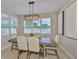 Bright dining room featuring a wooden table, upholstered chairs, and a modern light fixture at 2866 Quail Crest Ct, Valrico, FL 33594