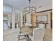Elegant dining room with a round table, chandelier, and mirrored wall, perfect for entertaining at 2866 Quail Crest Ct, Valrico, FL 33594