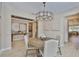 Bright dining room with a modern chandelier, round wooden table, and stylish decor at 2866 Quail Crest Ct, Valrico, FL 33594