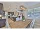 Open-concept dining area with a wooden table and seating, adjacent to the kitchen and staircase at 2866 Quail Crest Ct, Valrico, FL 33594