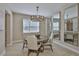 Stylish dining room featuring a round table, modern chandelier, and mirrored wall decor at 2866 Quail Crest Ct, Valrico, FL 33594