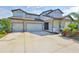 Beautiful two-story home featuring a stone facade, a three-car garage, and a well-manicured lawn at 2866 Quail Crest Ct, Valrico, FL 33594