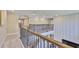 Second story hallway overlooking the entry with decorative railing and lighting at 2866 Quail Crest Ct, Valrico, FL 33594