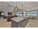 Open concept kitchen with granite island, pendant lights, stainless steel appliances, and access to living/dining areas at 2866 Quail Crest Ct, Valrico, FL 33594