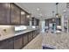 Gourmet kitchen featuring granite countertops, wood cabinetry, stainless steel appliances, and modern finishes at 2866 Quail Crest Ct, Valrico, FL 33594