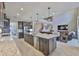 Open kitchen with stainless appliances, a large center island, pendant lights, and easy access to the living room at 2866 Quail Crest Ct, Valrico, FL 33594